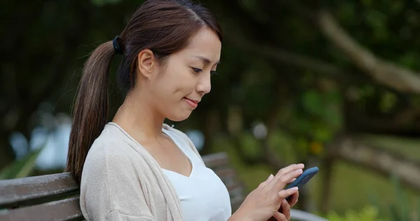 Vrouw aanraking op mobiele telefoon in de stad — Stockfoto