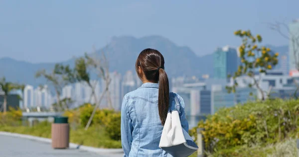 Vrouw kijkt rond in de stad — Stockfoto