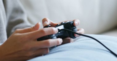 Kadın evde TV oyunu oynuyor.