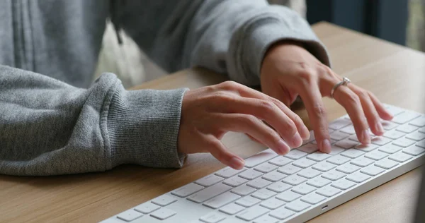 Woman type on desktop computer