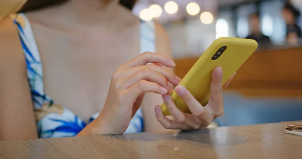 Woman use of mobile phone at restaurant