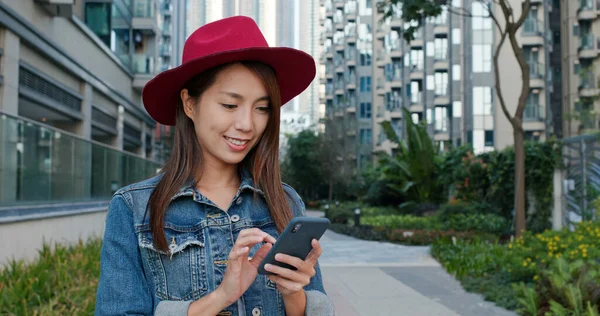 Woman wear hat and use of smart phone at outdoor