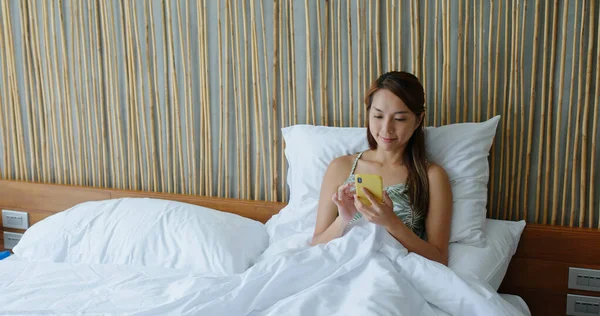 Женщина Смотрит Мобильный Телефон Кровати — стоковое фото