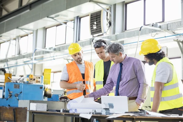 Garante con i lavoratori che esaminano i progetti — Foto Stock