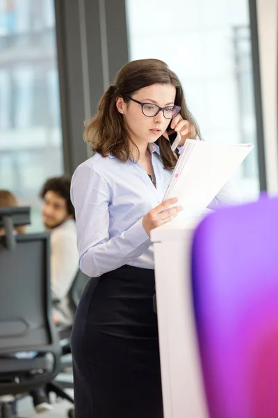 Businesswoman reading book in office — Stock Photo, Image