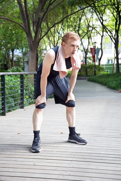 Man after run with towel — Stock Photo, Image