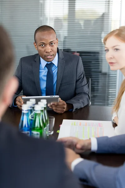 Businesswoman with male colleagues in conference room — Stock Photo, Image