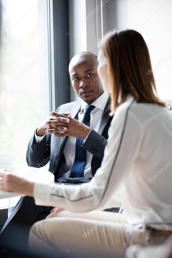 Businessman discussing with female colleague  