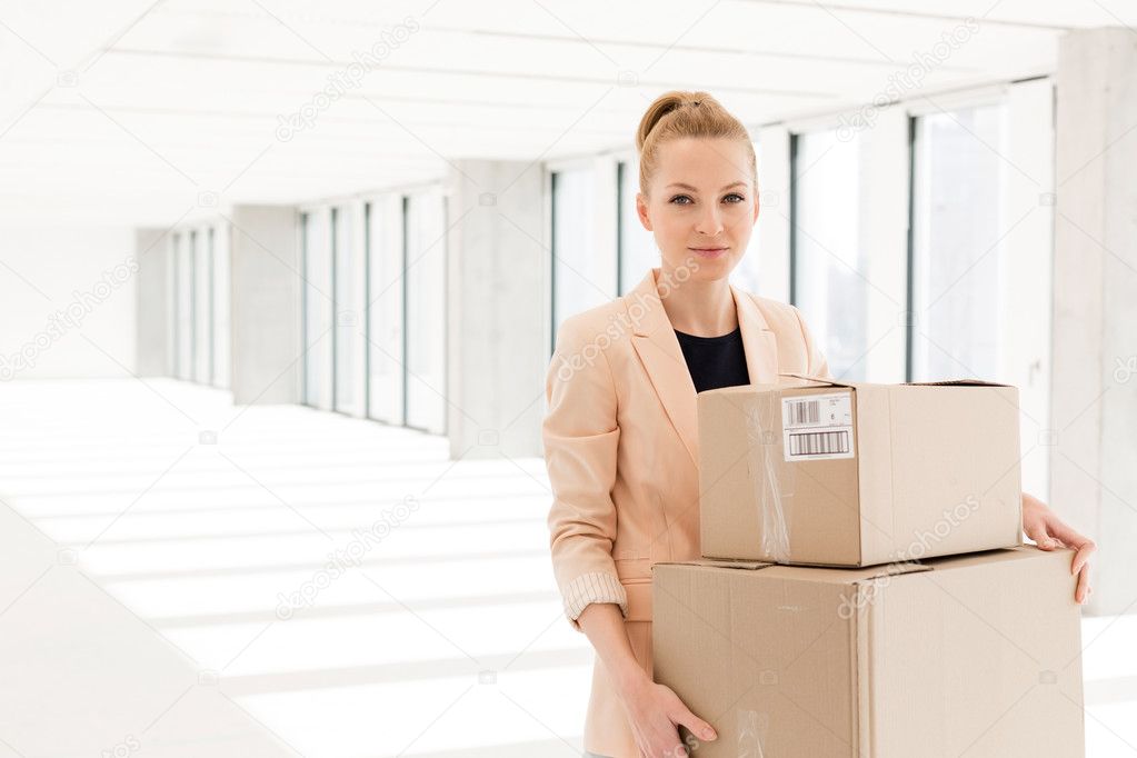 businesswoman carrying cardboard boxes 