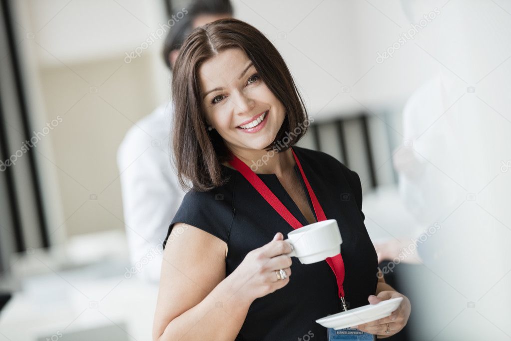 happy businesswoman with cup of coffee 