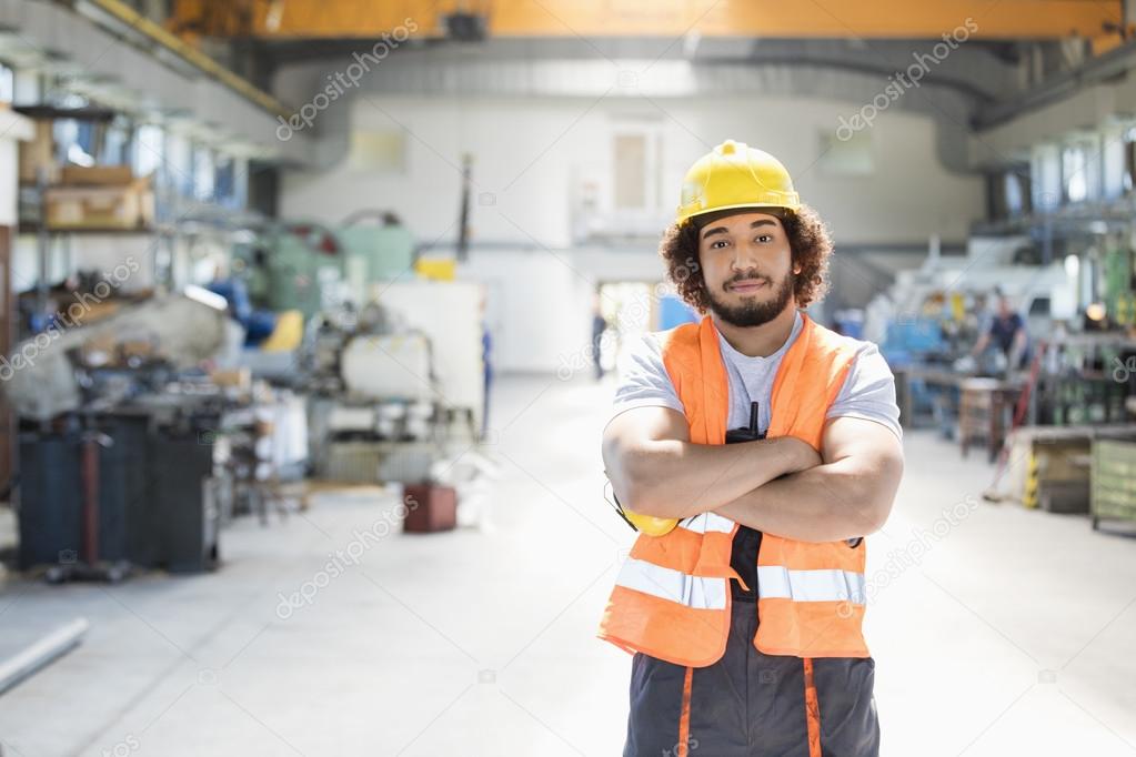 Manual worker with arms crossed in factory 