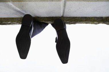 Feet dangling over wall clipart