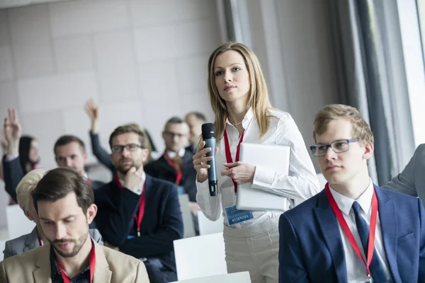 Businesswoman asking questions during seminar — Stock Photo, Image