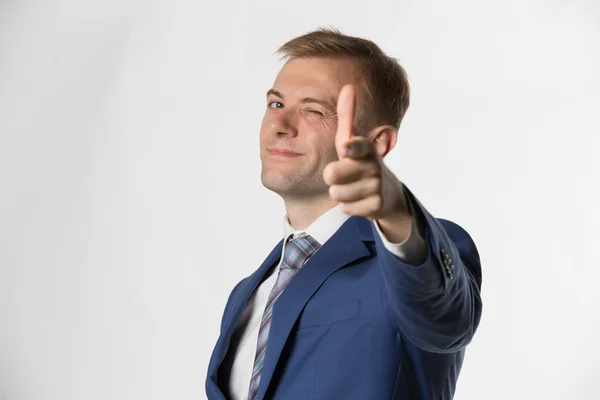 Businessman winking and pointing — Stock fotografie