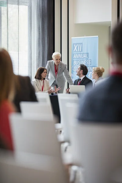 Mujer de negocios discutiendo con colegas durante el seminario — Foto de Stock