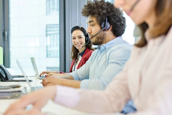 Businesswoman using headset and laptop — Stock Photo, Image