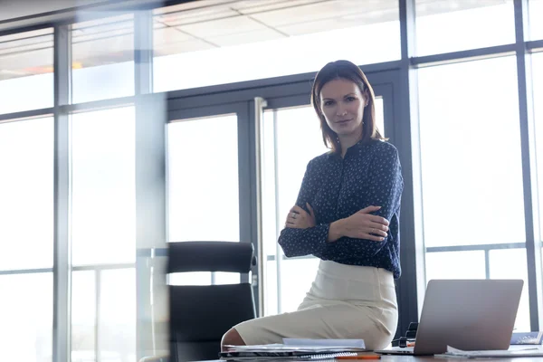 Confident woman with arms crossed