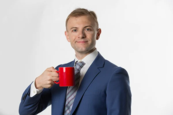 Businessman holding red mug — Stock fotografie