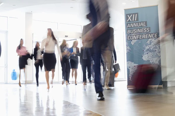 Business people walking in convention center — Stock Photo, Image