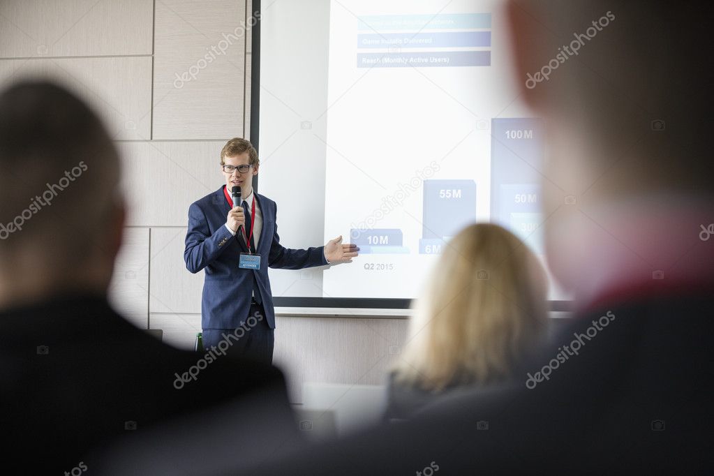 Businessman giving presentation at convention center 