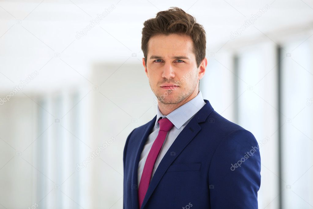 confident businessman wearing suit in office