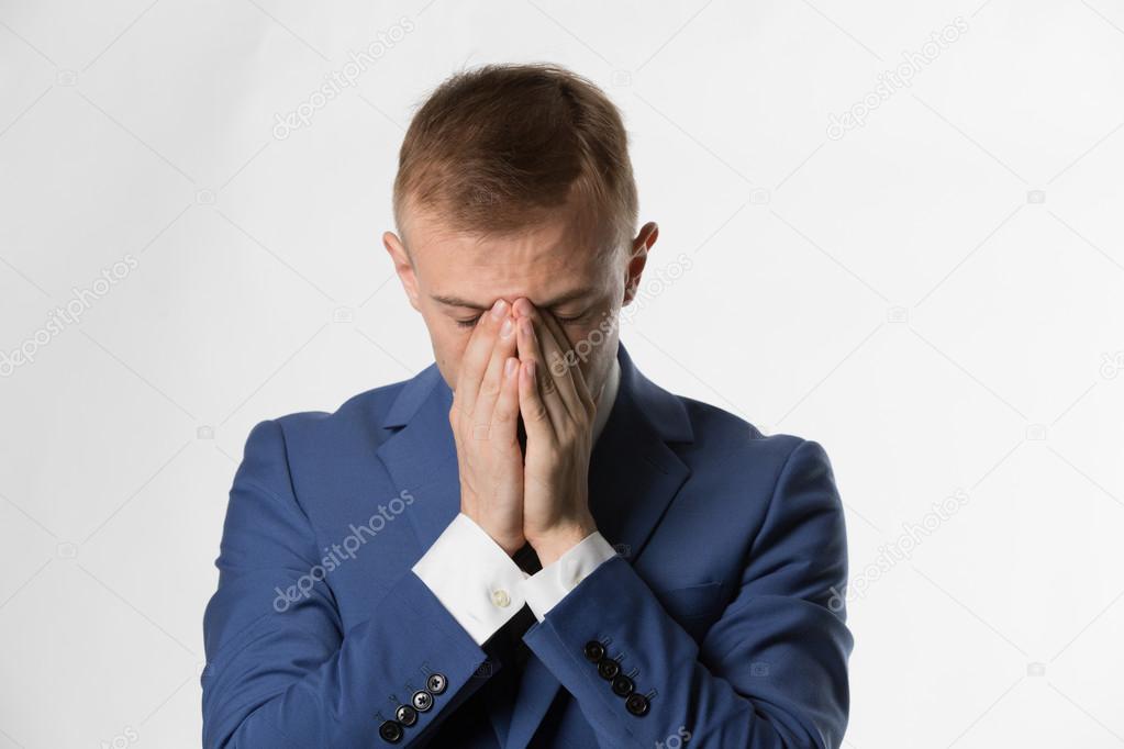 Businessman holding head in hands 