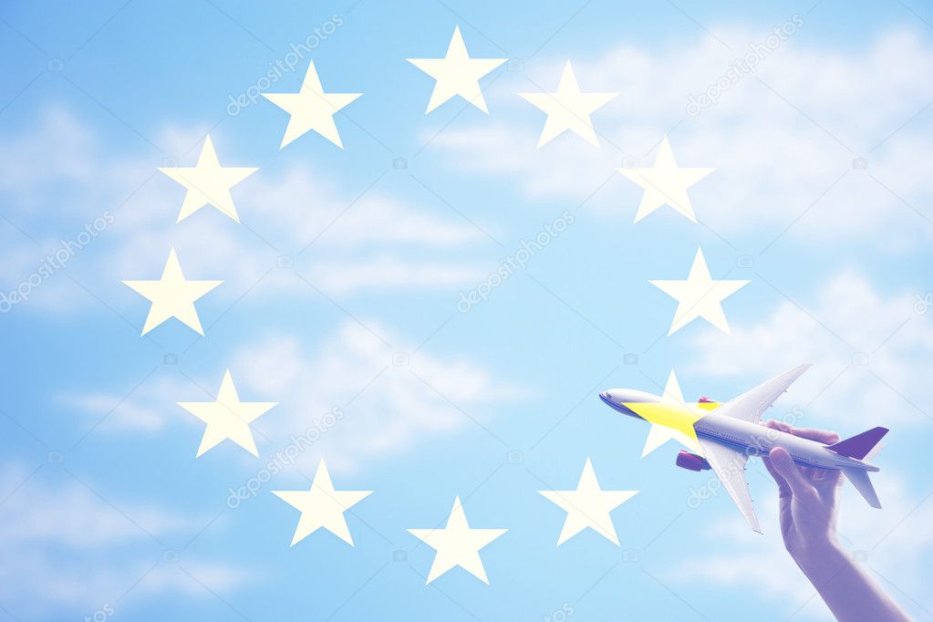 toy plane flying in from of EU Flag 