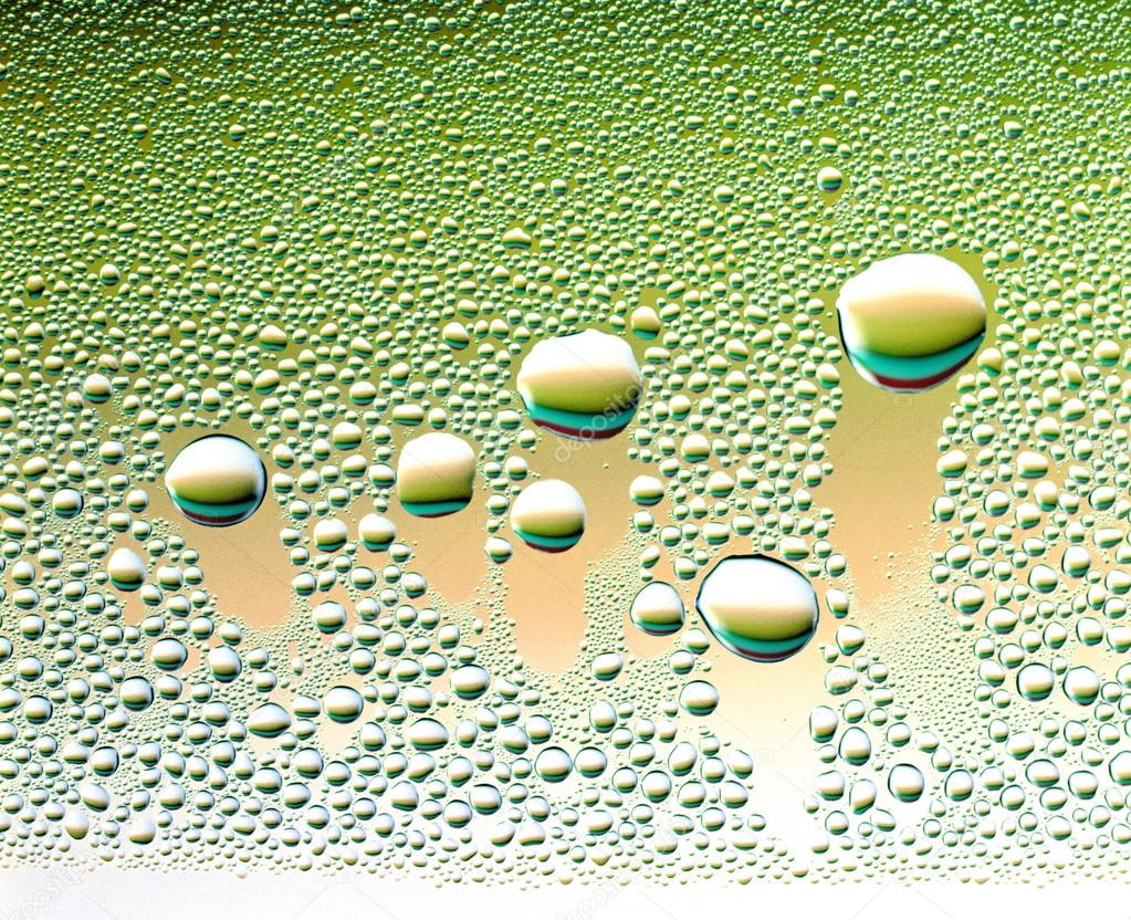 Water Droplets on green glass wall 