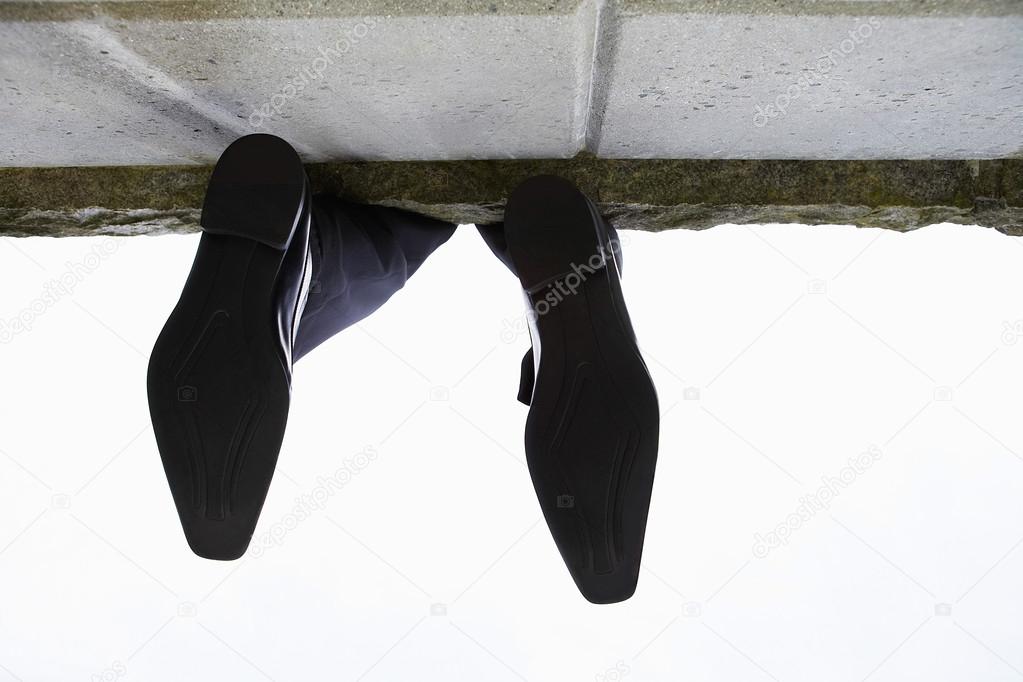 Feet dangling over wall
