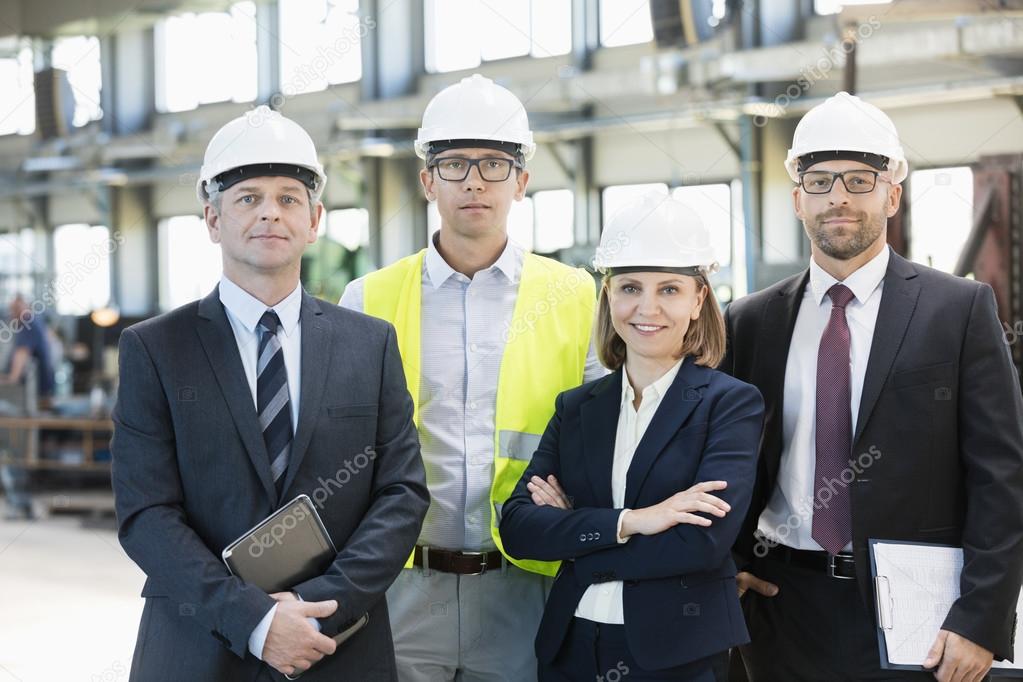 Confident business people in metal industry 