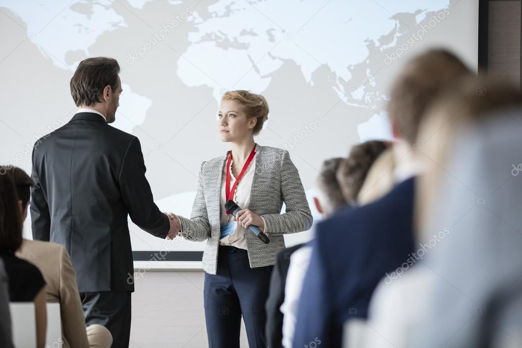 Business people shaking hands during seminar 