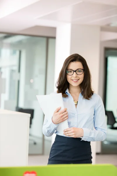 Businesswoman holding spiral book in office — Stock Photo, Image