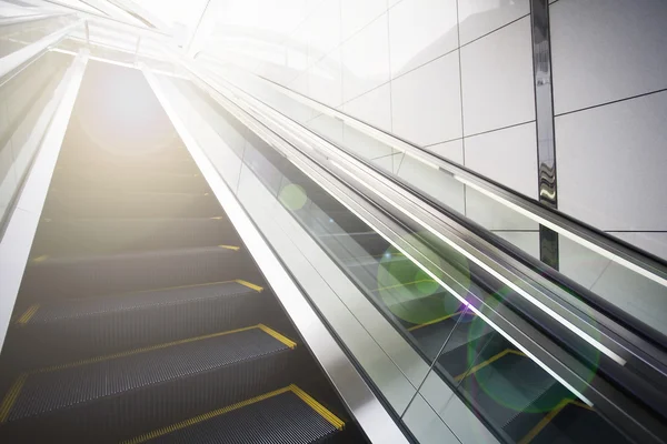 Empty escalator with lens flare — Stock Photo, Image