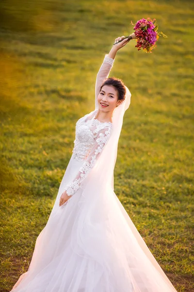 Happy bride holding bouquet — Stock Photo, Image