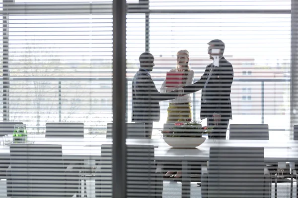 Businessmen shaking hands by female colleague — Stock Photo, Image