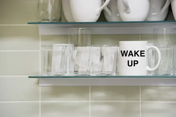 Cup on shelf with Wake Up Text — Stock Photo, Image