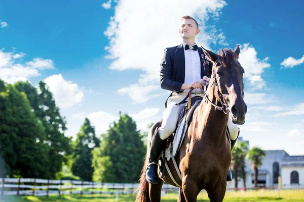 Thoughtful man sitting on horse — Stock Photo, Image