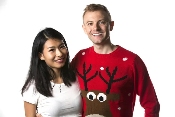 Happy multiethnic couple in christmas jumpers — Stockfoto