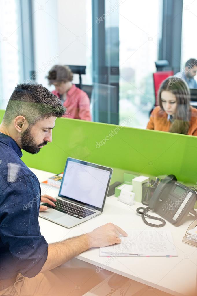 Businessman using laptop in office 