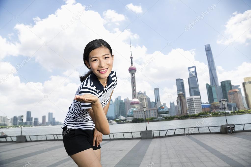 happy woman against Pudong skyline
