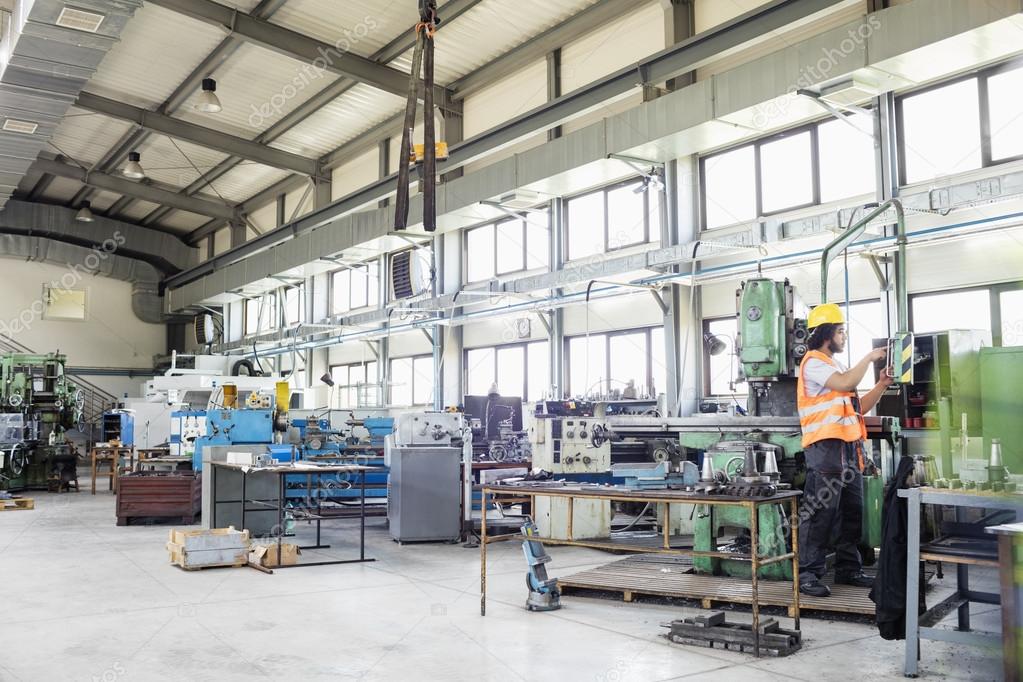 Worker operating machinery in metal industry 