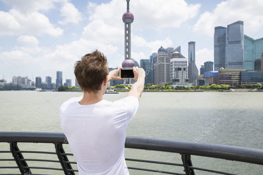 man photographing Oriental Pearl Tower 