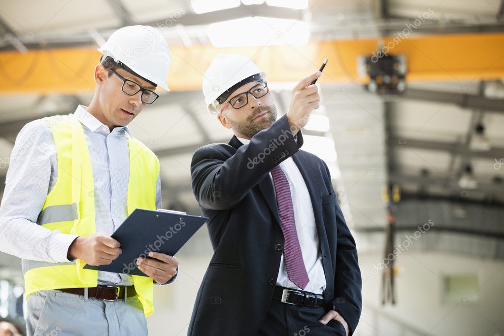 Businessman with supervisor having discussion in industry 