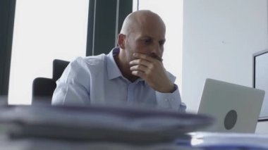 Ciddi kel ofisinde çalışan iş adamı 