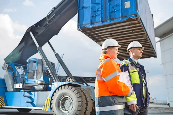 Male and female workers in shipping yard — Stock Photo, Image