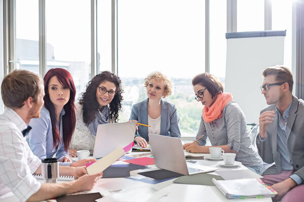 Business colleagues discussing in creative office