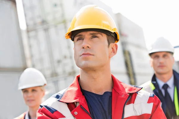 Confident male worker with colleagues — Stock Photo, Image