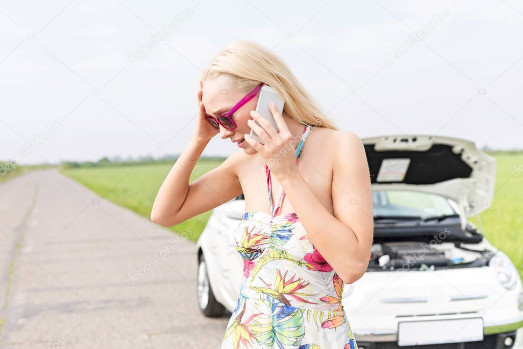 Worried woman using mobile phone