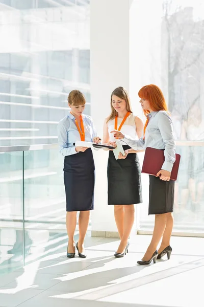 Businesswomen discussing over documents — Stock Photo, Image