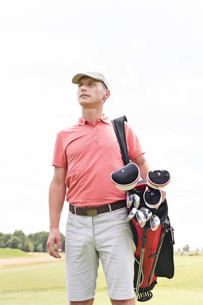 Thoughtful middle-aged man with golf bag — Stock Photo, Image